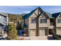 Inviting two-story townhome featuring a two-car garage and well-maintained landscaping at 31101 Black Eagle Dr # 202, Evergreen, CO 80439