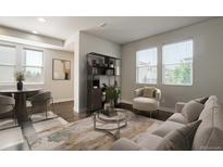 Bright living room featuring contemporary furnishings, modern shelving, and ample natural light from large windows at 16069 E Elk Dr, Denver, CO 80239