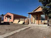 Exterior view of two homes with dirt yards, needing landscaping and improvements at 723 Newton St, Denver, CO 80204