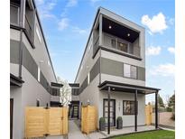 Modern three-story home featuring a covered porch and second-floor balcony at 1745 Lowell Blvd, Denver, CO 80204