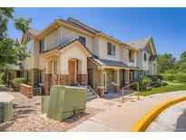 Charming townhome featuring well-maintained landscaping and a welcoming entrance on a sunny day at 22560 E Ontario Dr # 204, Aurora, CO 80016
