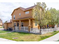 Charming two-story home with a manicured lawn, white picket fence, and inviting front porch at 3760 Ute Mountain Trl, Castle Rock, CO 80109