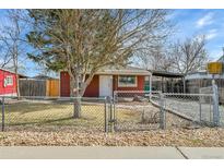 Charming single-story home featuring a fenced yard and mature tree at 6670 Hooker St, Denver, CO 80221