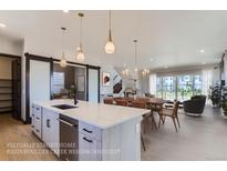 Modern kitchen with island, stainless steel appliances, and breakfast bar at 16567 Peak St, Broomfield, CO 80023