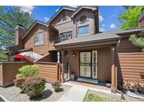 Charming two-story townhome with a private, fenced front patio and mature landscaping at 8010 Holland Ct # D, Arvada, CO 80005