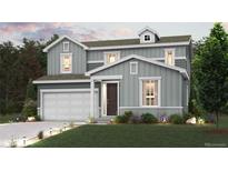 Two-story house with gray siding, attached garage, and landscaping at 1465 Bloom St, Brighton, CO 80601