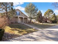 Two-story house with a landscaped yard and attached garage at 7944 E Lowry Blvd, Denver, CO 80230