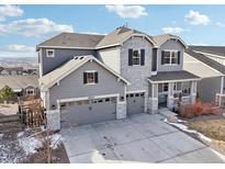 Beautiful two-story home with grey siding, stone accents, and a three-car garage at 20223 Terrace View Dr, Parker, CO 80134