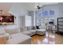 Bright living room with vaulted ceilings, large windows, and hardwood floors at 6821 W Yale Ave, Lakewood, CO 80227