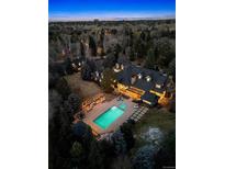Stunning aerial view of a backyard oasis, pool, and meticulously landscaped grounds at dusk at 4301 S Lafayette St, Cherry Hills Village, CO 80113