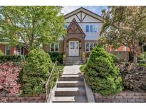 Charming Tudor-style home with a brick facade, lush landscaping, and inviting front entrance at 1250 S Vine St, Denver, CO 80210