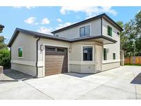 Inviting two-story home featuring a concrete driveway and an attached garage with automatic door at 3224 W Dakota Ave, Denver, CO 80219