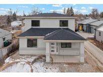 Two-story house with gray siding, dark roof, and small front porch at 3224 W Dakota Ave, Denver, CO 80219