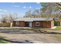 Charming single-story home featuring a well-maintained yard and inviting facade at 8182 3Rd Ave, Arvada, CO 80007