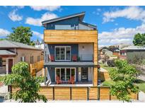 Modern three-story home featuring wood accents and a welcoming front porch at 3657 Pecos St, Denver, CO 80211