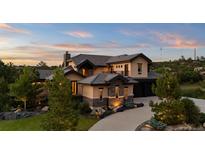 Beautiful two-story home with stone accents, manicured landscaping, and a private balcony at 1803 Avenida Del Sol, Castle Rock, CO 80104