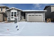 Charming single-story home featuring stone accents, a two-car garage, and a well-maintained lawn in a desirable community at 24779 E 39Th Ave, Aurora, CO 80019