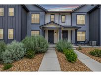 Charming townhome showcasing well-maintained landscaping and a welcoming front entrance at 185 Ambrose St, Erie, CO 80516