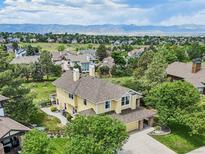 Gorgeous two-story home with mountain views, mature trees, and a well-manicured lawn creating an inviting curb appeal at 9385 Prairie View Dr, Highlands Ranch, CO 80126