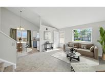 Open floor plan featuring a comfortable living room with a dining nook and kitchen, great for entertaining at 17593 E Temple Dr, Aurora, CO 80015