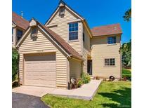 Charming two-story home with attached garage and well-manicured front lawn at 10349 W Fair Ave # A, Littleton, CO 80127