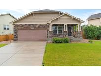 Charming single-Gathering home featuring stone accents, a well-manicured lawn, and a two-car garage at 3838 Brush Rd, Castle Rock, CO 80108