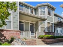 Charming two-story home with a covered porch and landscaped front yard in a residential neighborhood at 1918 Depew St, Lakewood, CO 80214