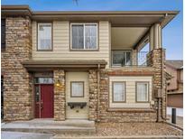 Attractive two-story condo featuring a red door, stone accents, and a balcony on the second floor at 11391 Navajo Cir # B, Westminster, CO 80234