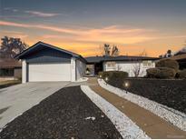 Charming home with an attached garage and beautifully landscaped front yard, perfect for curb appeal at 6585 E Nevada Pl, Denver, CO 80224