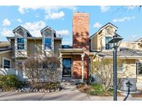 Charming exterior of a townhouse with a brick chimney, dormer windows and a front porch at 2891 W Long Dr # D, Littleton, CO 80120