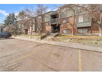 Brick building exterior with parking and landscaping at 3656 S Depew St # 104, Denver, CO 80235