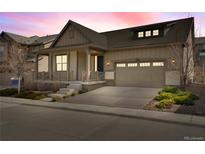 Charming single-Gathering home featuring a welcoming front porch and attached two-car garage at 9772 Taylor River Cir, Littleton, CO 80125