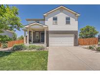 Charming two-story home with a well-manicured lawn and a two-car garage at 25097 E Lake Dr, Aurora, CO 80016