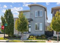 Contemporary home with a stone accent, well-manicured lawn, and inviting front entrance at 6777 Mariposa St, Denver, CO 80221