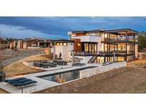 Expansive modern home with outdoor kitchen, pool and dining areas that offers a luxurious outdoor entertaining at 5140 S Kearney Ct, Greenwood Village, CO 80111