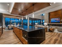 Gourmet kitchen featuring a large island, breakfast bar, and an open concept design at 5140 S Kearney Ct, Greenwood Village, CO 80111