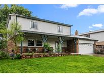 Charming two-story home with a welcoming front porch, fresh lawn, and attached two car garage at 4550 E 121St Pl, Thornton, CO 80241