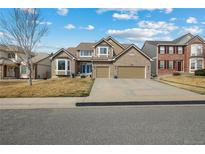 Charming two-story home with a three-car garage and a well-maintained front yard and lovely curb appeal at 19665 E Ida Pl, Aurora, CO 80015
