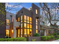 Modern multi-story home featuring a combination brick and stucco facade with large windows providing ample natural light at 8071 E 29Th Ave, Denver, CO 80238