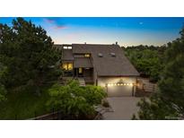 Beautiful two-story home with a well-manicured lawn, lush landscaping, and an attached two-car garage at 5812 Irish Pat Murphy Dr, Parker, CO 80134