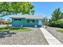 Charming blue single-story home with manicured lawn, rock landscaping, and a bright and welcoming exterior at 1500 S Wolcott Ct, Denver, CO 80219