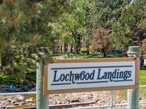 Lochwood Landing community sign near bridge and stream at 10970 W Florida Ave # 225, Lakewood, CO 80232