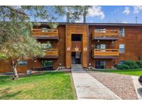 Charming brown wood condo with multiple balconies and well-maintained lawn and landscape at 331 Wright St # 108, Lakewood, CO 80228