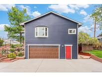 Two-story home featuring a garage and a red front door at 401 N Columbine St, Golden, CO 80403