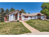 Charming single-story home boasting a well-manicured lawn, lovely desert landscaping, and a neutral color palette at 6663 S Prescott Way, Littleton, CO 80120
