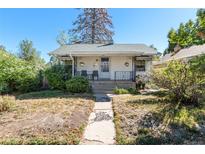 Charming single-story home with a welcoming front porch and well-maintained landscaping at 4110 Yates St, Denver, CO 80212