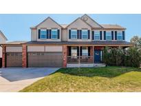Charming two-story home featuring a welcoming front porch and a spacious three-car garage at 11680 Crow Hill Dr, Parker, CO 80134