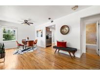 Bright living room features hardwood floors, a modern dining set, and a stylish bench at 951 S Osage St, Denver, CO 80223