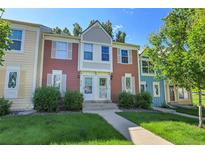 Inviting townhome with a well-manicured lawn and a charming, colorful facade at 9320 W Ontario Dr, Littleton, CO 80128