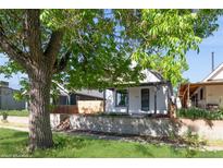 Charming home with a well-maintained front yard and inviting curb appeal, including mature tree coverage at 3817 Osage St, Denver, CO 80211